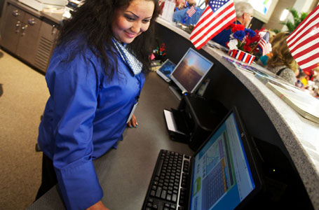 Employee working a kiosk counter